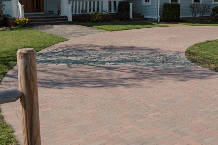 Herringbone pattern driveway with cobblestone aprons in Jamestown, Rhode Island using Copthorne pavers from Unilock