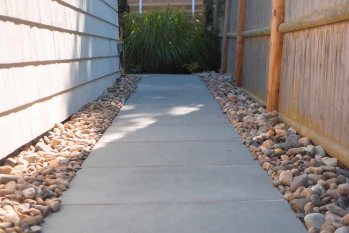 Bluestone walkway lined with river rocks.