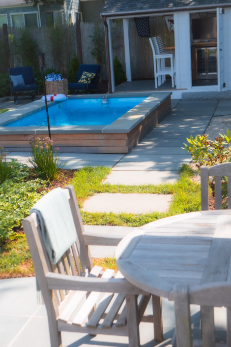Bluestone stepping stones leading from a bluestone patio to a small plunge pool.