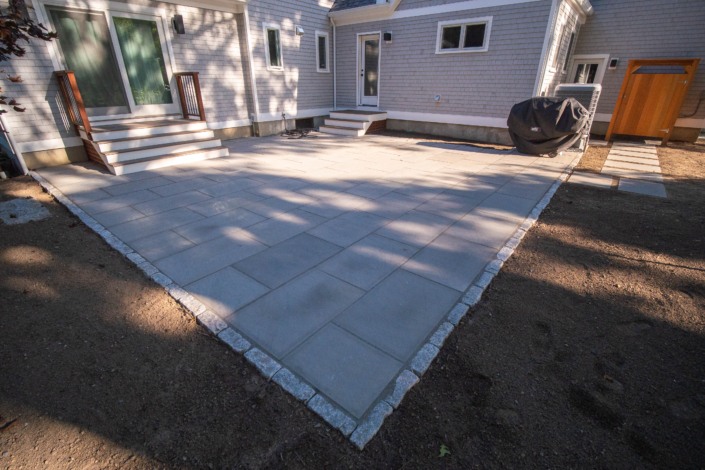 Thermal bluestone patio with a cobblestone border.