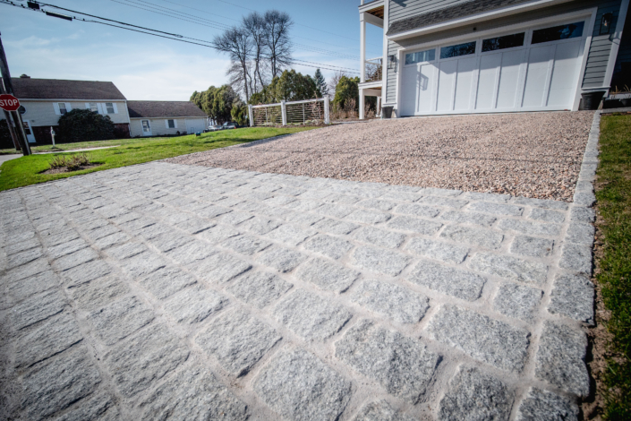 Cobblestone apron at the bottom of a crushed stone driveway.