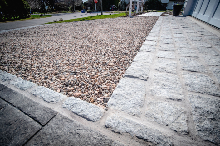 Cobblestone apron and border around a crushed stone driveway in Jamestown, Rhode Island.
